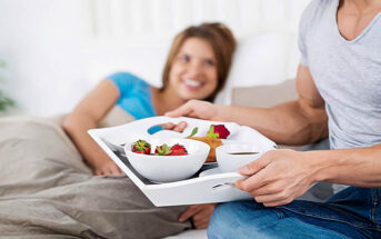 man bringing partner breakfast in bed - illustrating treating someone well