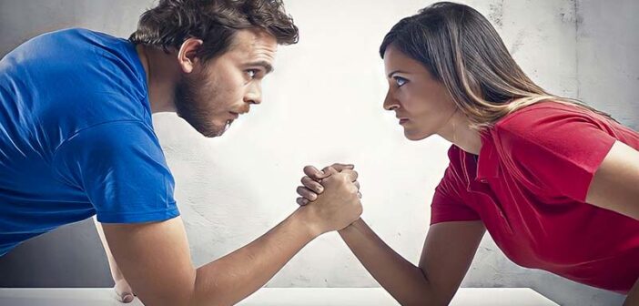 man and woman having arm wrestle because they always need to be right