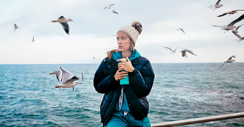 a woman at the coast with seagulls - illustrating that she has lost herself in a relationship