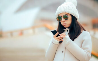 woman looking at phone wondering why she is still single