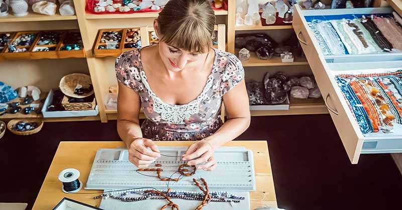 woman making a necklace illustrating finding a hobby