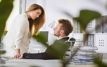 man and woman having an affair in an office