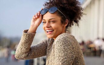 young woman smiling with sun on her face - concept of improving your life