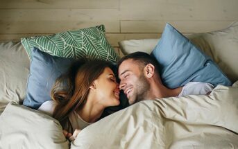 happy man and woman in bed - illustrating what a man wants in a woman