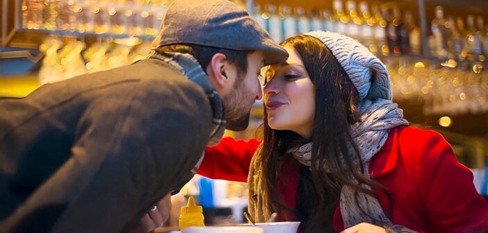 couple kissing in bar - illustrating falling in love too easily