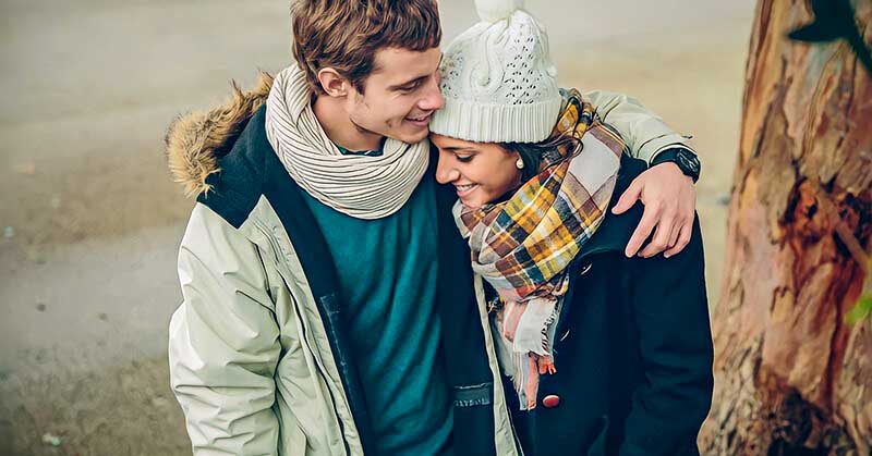 young woman touching man on arm to illustrate having feelings for someone else