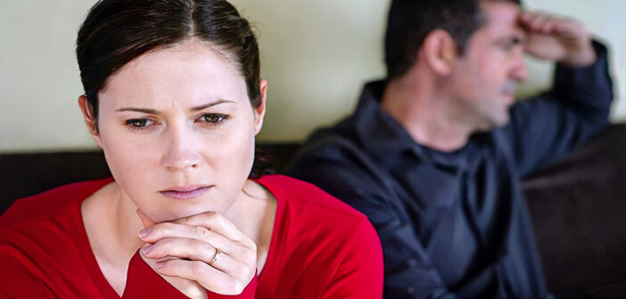 woman looking sad with husband in background - illustrating feeling trapped in a marriage