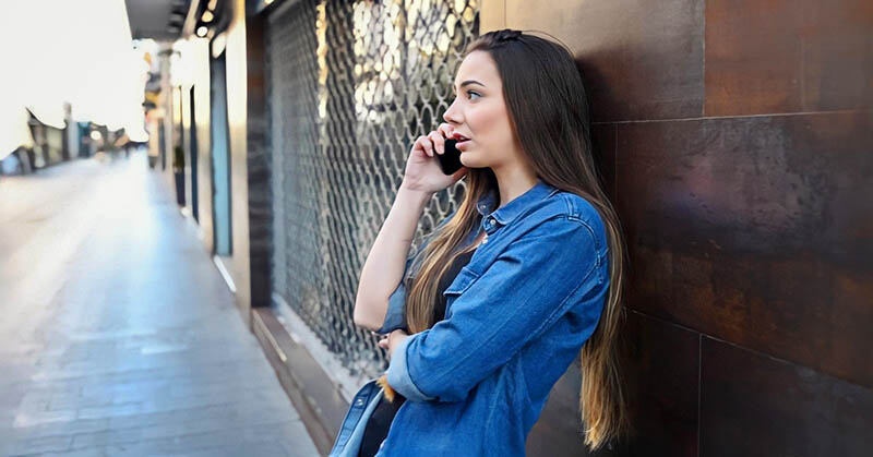 annoyed woman talking on the phone to absent boyfriend who doesn't have time for her
