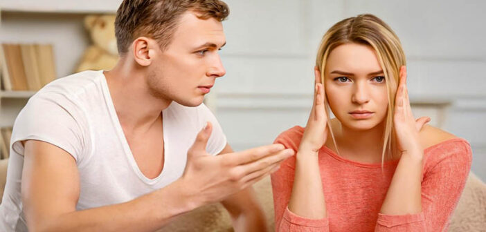 young woman covering her ears from relationship confrontation