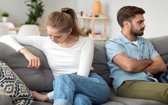 stubborn man with crossed arms facing away from despondent woman