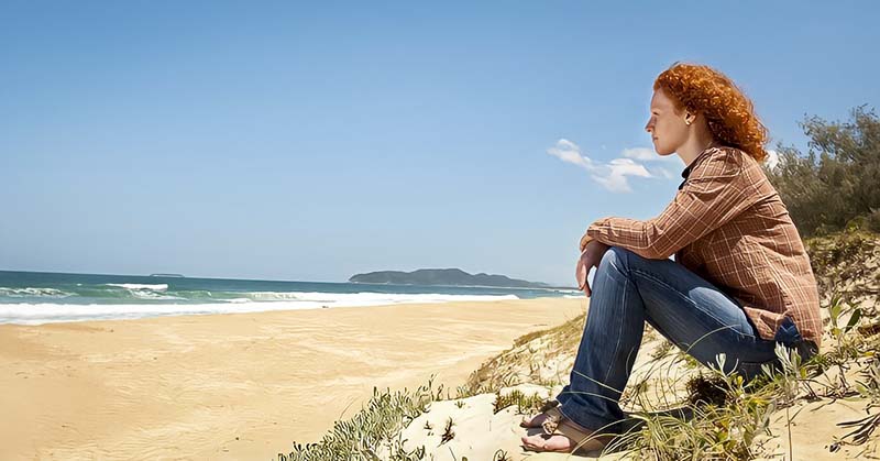 woman looking out across ocean wondering what things to believe in