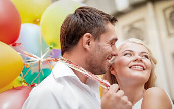 couple celebrating boyfriend's birthday with balloons
