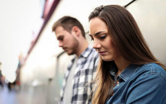couple leaning against wall thinking the other is too good for them