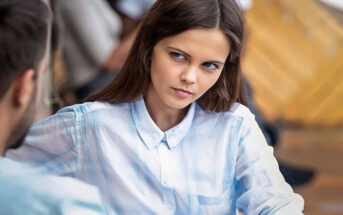 woman with doubtful look on her face as she listens to her boyfriend lie to her