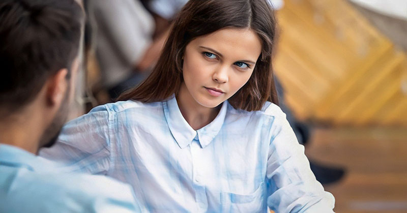 woman with doubtful look on her face as she listens to her boyfriend lie to her