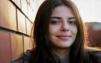 young woman smiling toward camera illustrating being a nice person