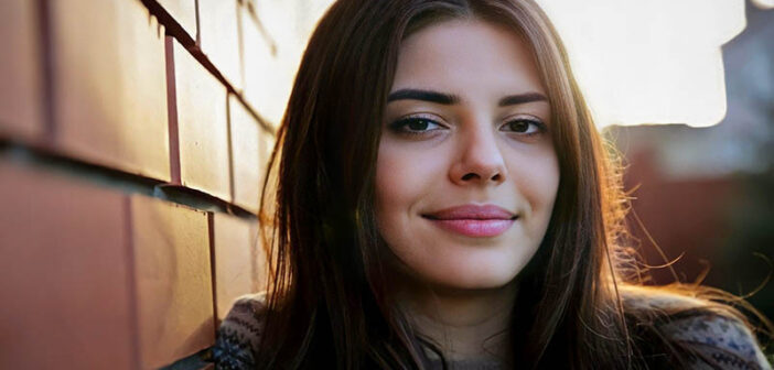 young woman smiling toward camera illustrating being a nice person