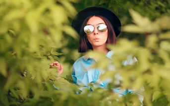 woman in bushes spying on her ex who has moved on