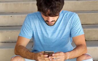 guy looking down at his phone illustrating that he likes to text but not call