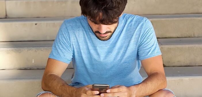 guy looking down at his phone illustrating that he likes to text but not call