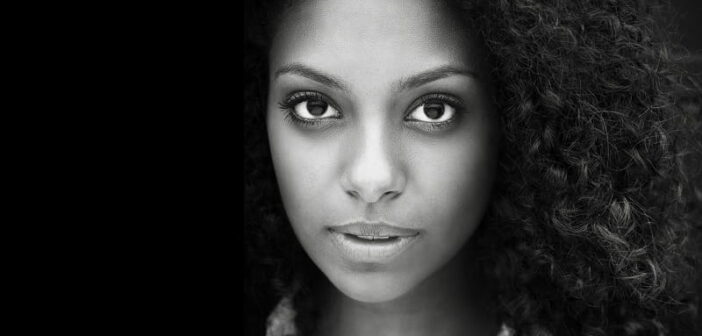 African American woman in black and white looking at camera - emotional self-care