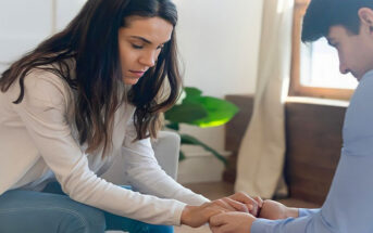 couple leaning toward each other holding hands to illustrate forgiving a cheater