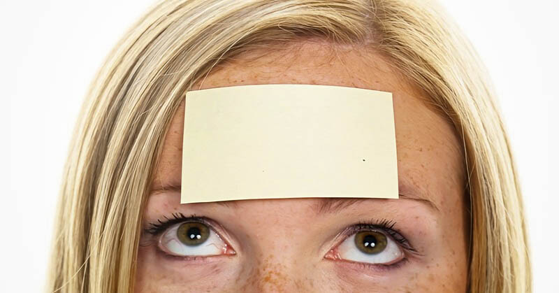 woman with sticky note on her forehead - illustrating labeling people