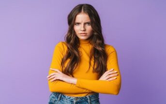young woman with crossed arms looking offended by something or someone