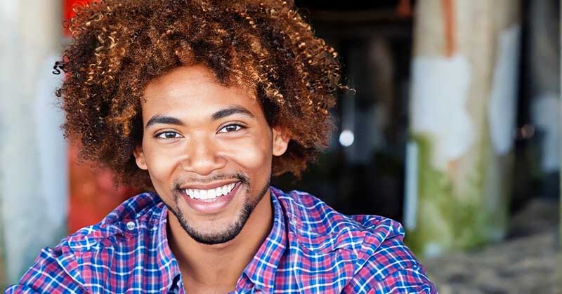 African American man smiling - illustrating the good qualities to look for in a man