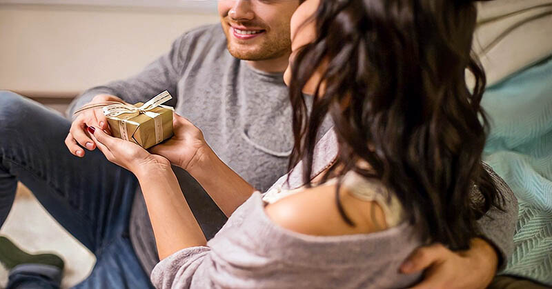 man giving woman a present illustrating the receiving gifts love language
