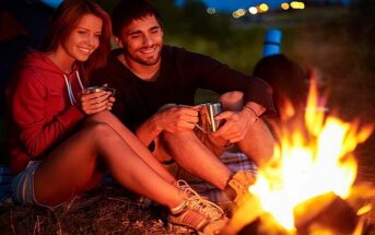 couple having romantic time around a campfire