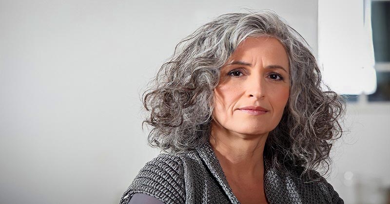 middle aged woman with gray hair illustrating wisdom and intelligence