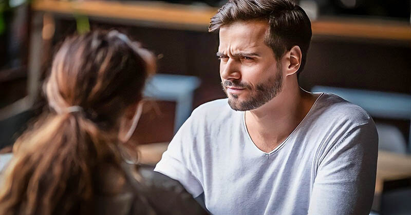 a guy looking confused and doubtful at girl - illustrating that he doesn't know what he wants