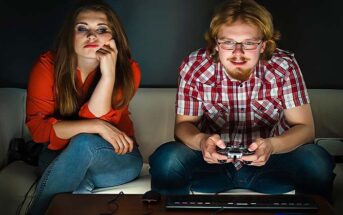 emotionally immature man playing video games and ignoring his girlfriend