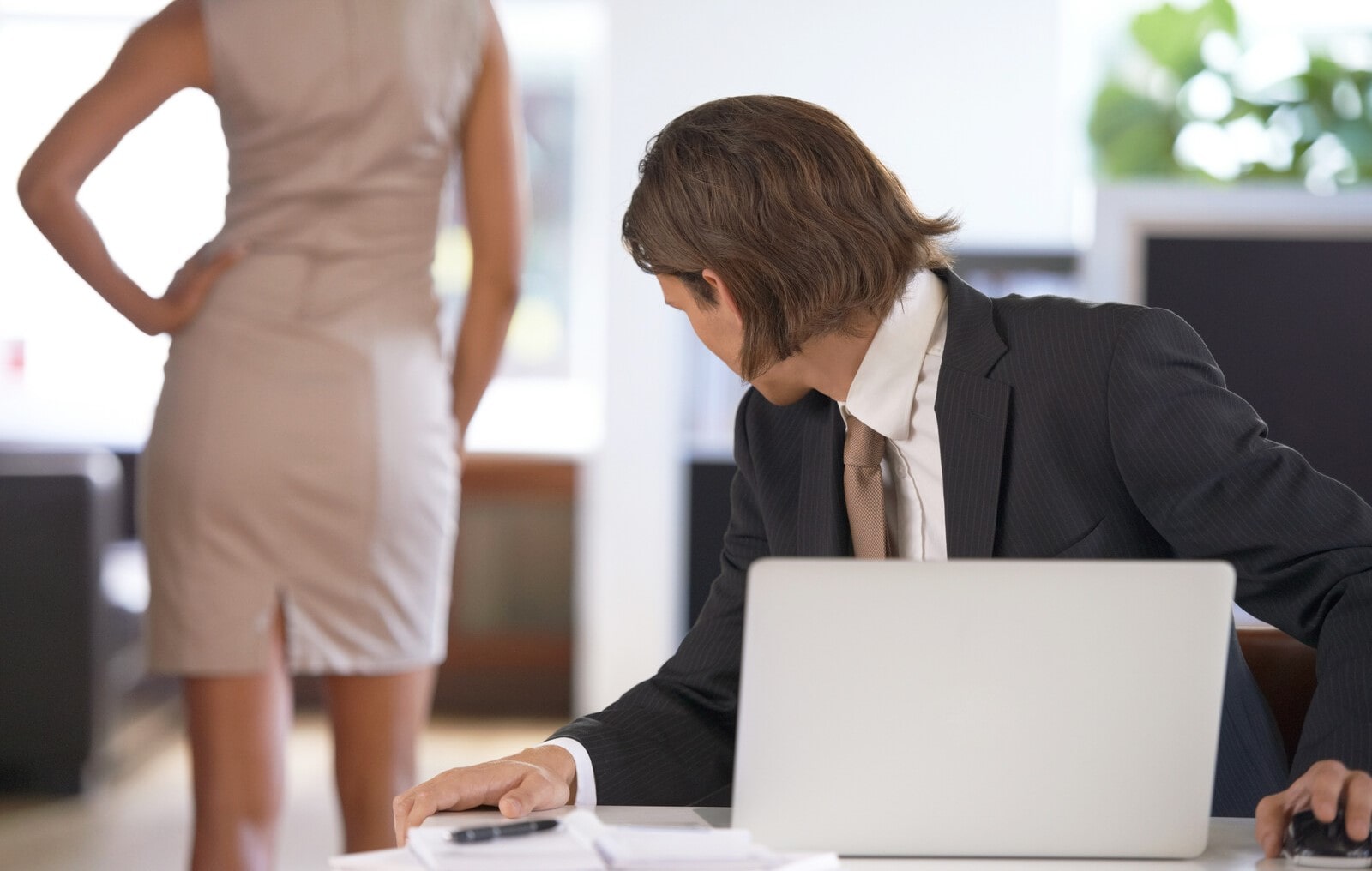 man checking his female colleagues backside out