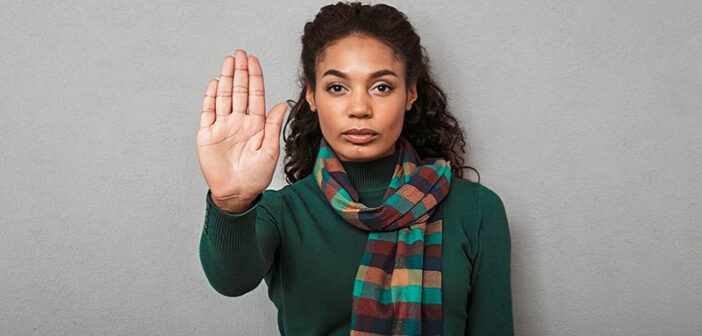 woman holding palm up to demonstrate her boundaries when someone doesn't respect them