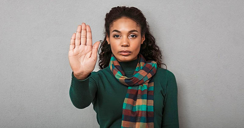 woman holding palm up to demonstrate her boundaries when someone doesn't respect them