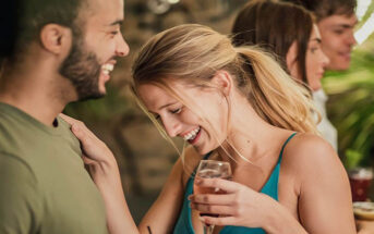 man and woman flirting with each other in a bar