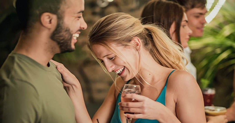 man and woman flirting with each other in a bar