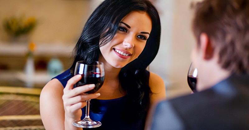 woman on first date with head tilted to one side indicating that it's going well