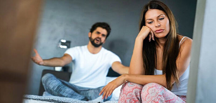 unhappy looking couple going through a rough patch in their relationship