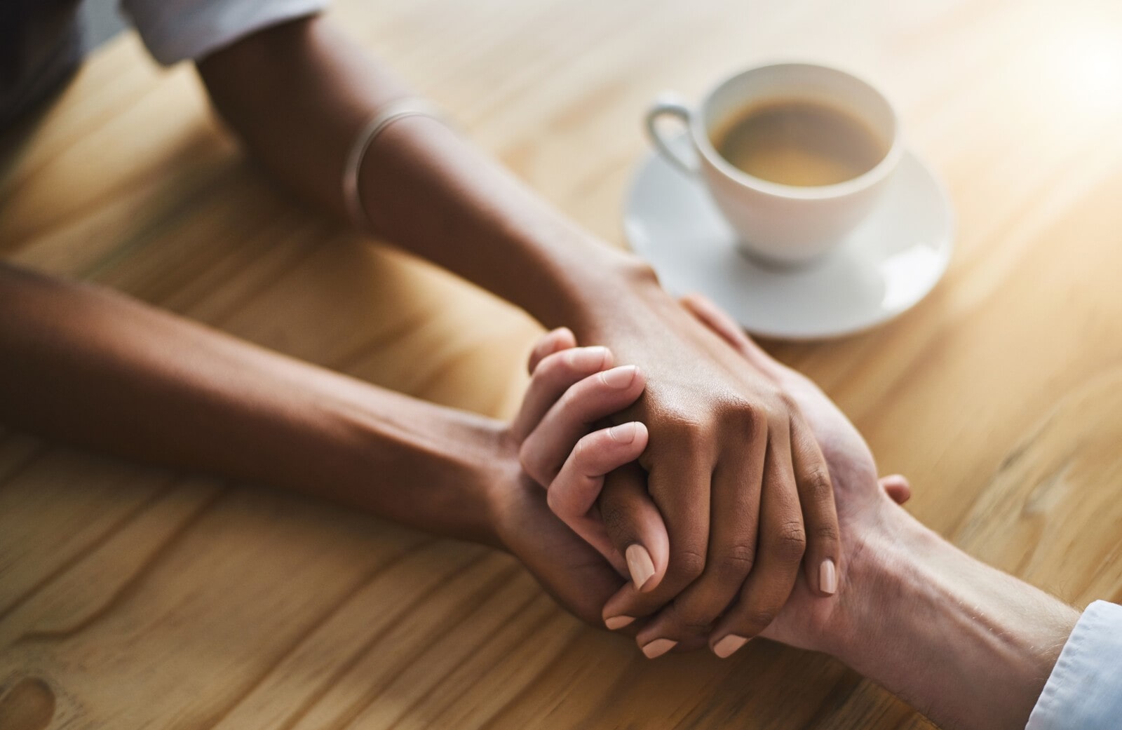 two people holding hands showing support