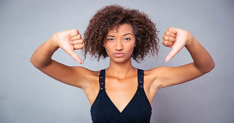 woman with both her thumbs down illustrating complaining about things
