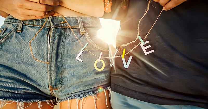 closeup of couple holding string with l-o-v-e letters
