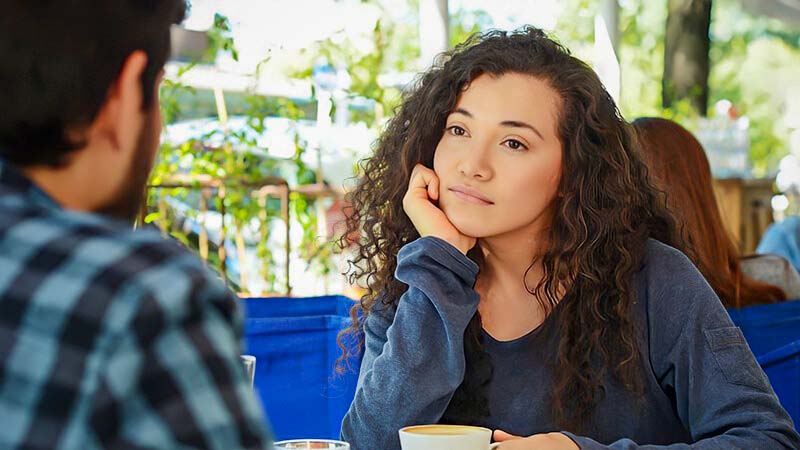 young woman looking at date unsure whether she is attracted to him and whether attraction can grow