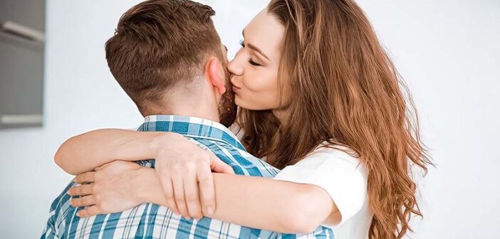 woman cuddling and kissing boyfriend to illustrate loving too much