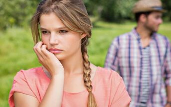 unsure woman with boyfriend in background illustrating signs they might break up