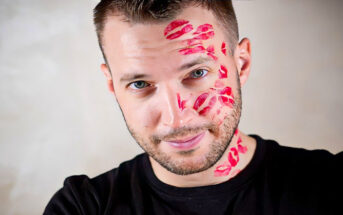 man with lots of lipstick kiss marks on his face illustrating that he is a player