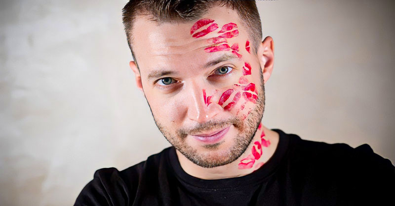 man with lots of lipstick kiss marks on his face illustrating that he is a player