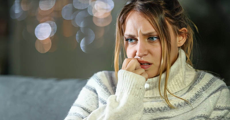 woman biting her nails illustrating that she is scared of dating